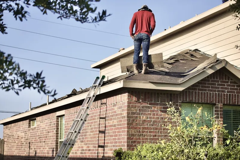 Professional roofer working on a residential roof in Reseda